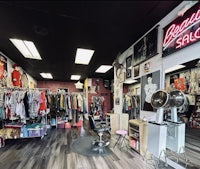 a barber shop with a lot of clothes on display